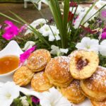 ebelskivers on a white tray with guava jam filling in the center.