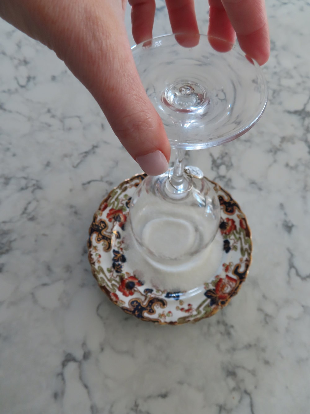 Gently tap the rim into the sugar.