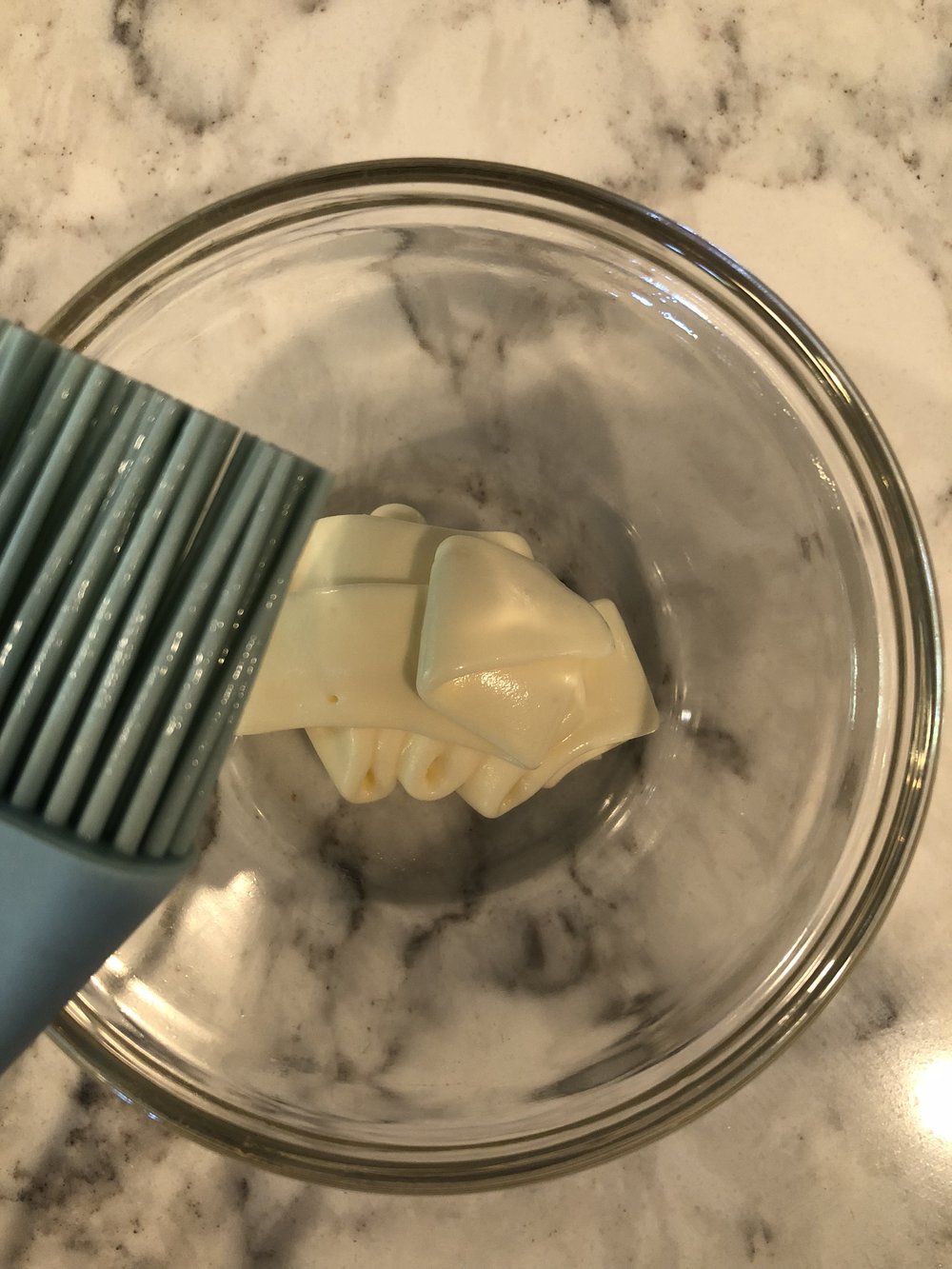 Quickly brush the hot corn with a light layer of mayo