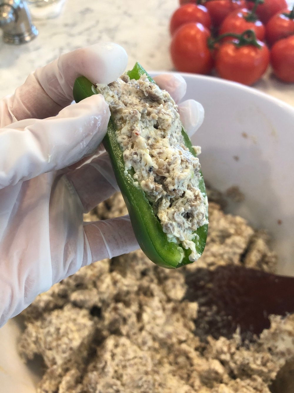 Step 3 - Cut jalapeno in half lengthwise and stuff with sausage mixture.