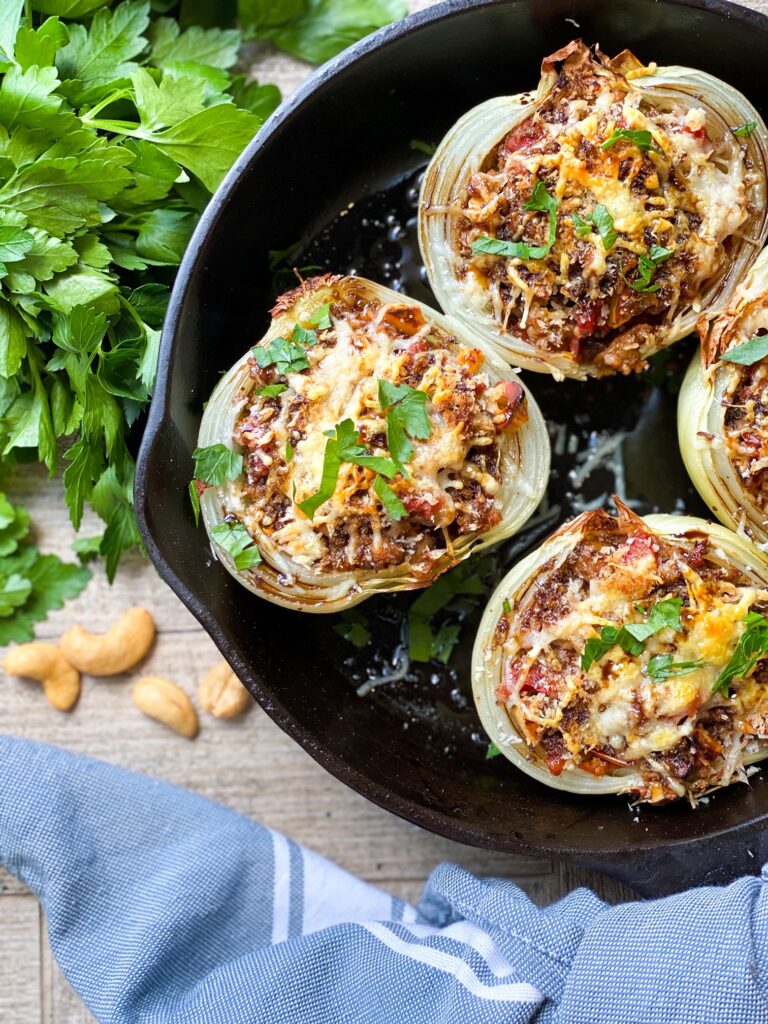 SAUSAGE STUFFED ONIONS in a cast iron skillet