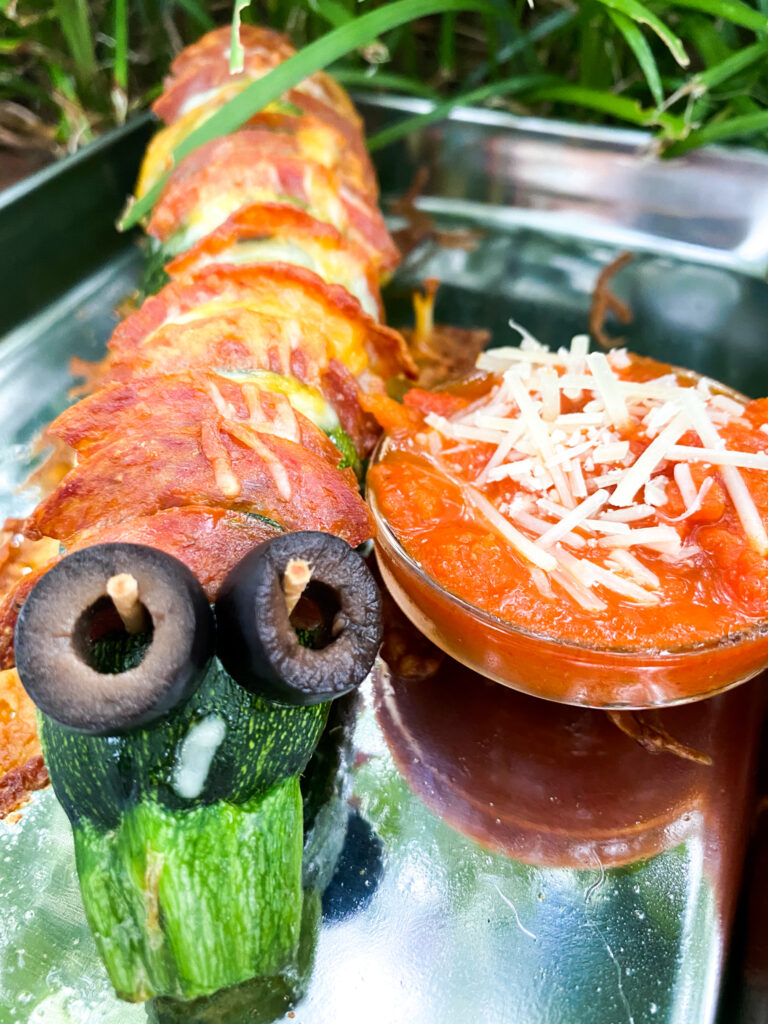 Zucchini stuffed with pepperoni and cheese made to look like a Caterpillar