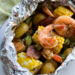 Shrimp, corn on the cob, potatoes and andouille sausage in a foil packet