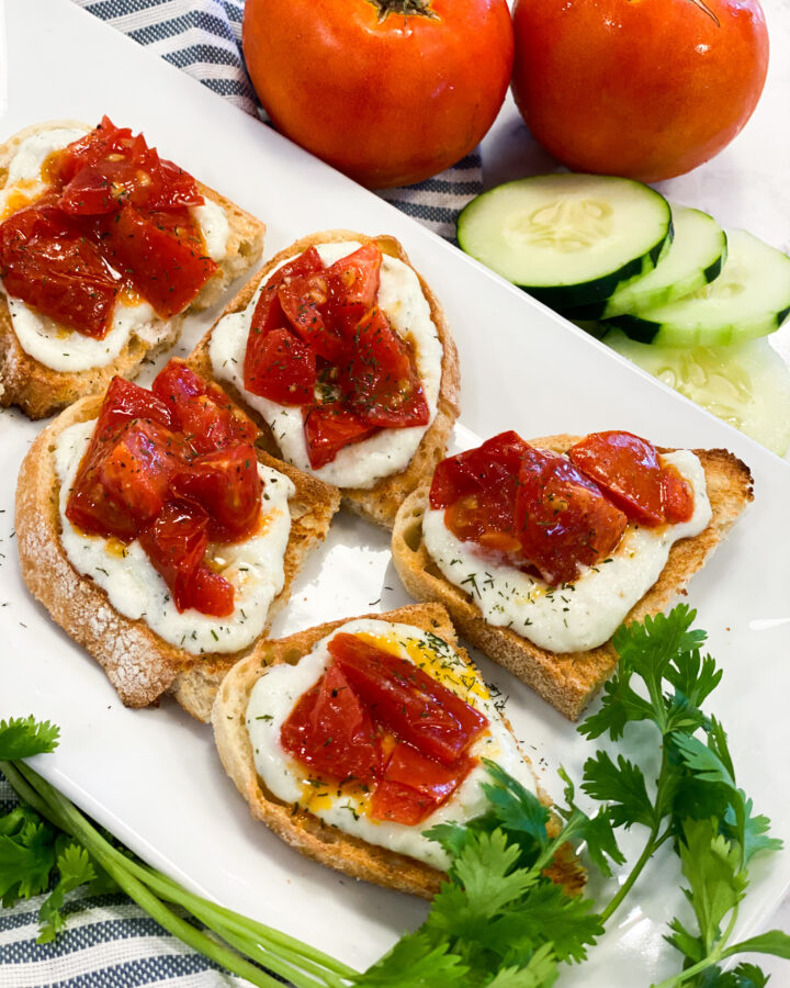 Toasted bread topped with the ricotta cheese spread and roasted tomatoes.