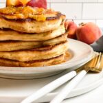 Tall stack of peach pancakes