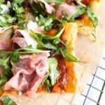 Eat Like Home Pasta Sauce on a puff pastry tart with arugula, olive and sun dried tomatoes